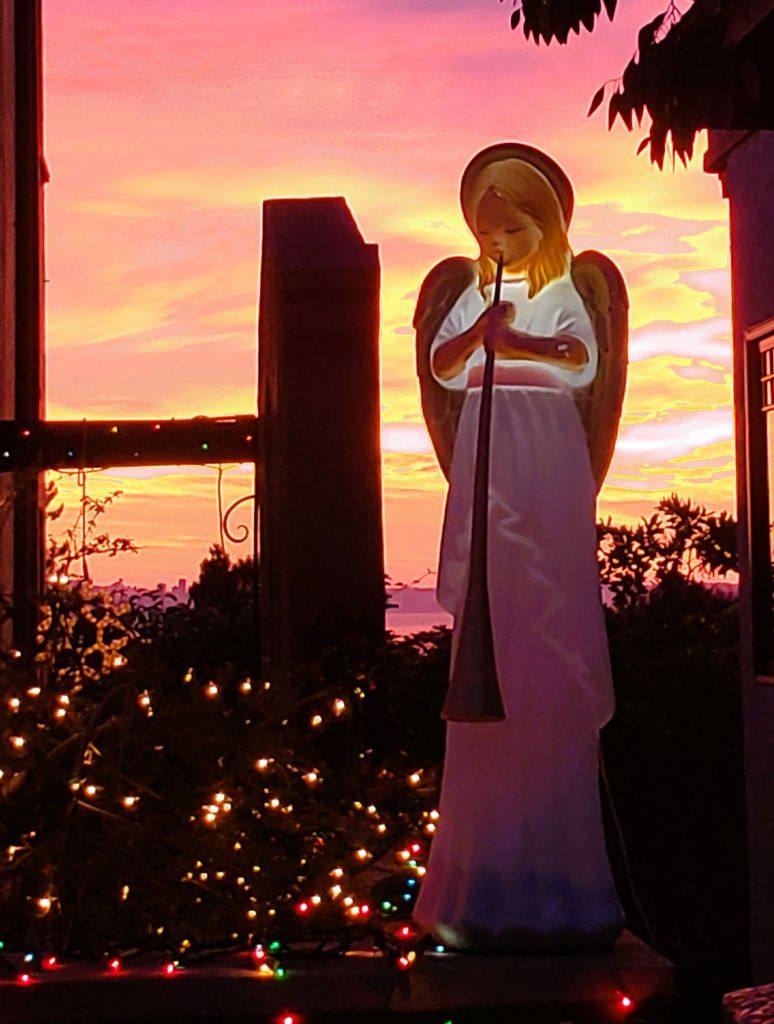 Angel figurine in front of the sunset